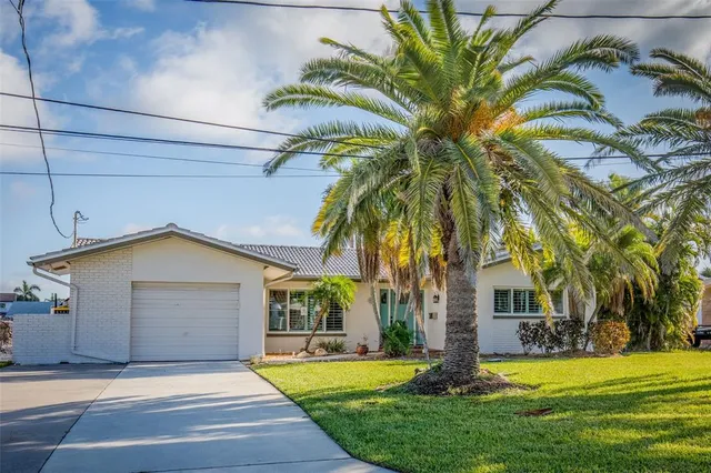 a front view of house with yard and green space