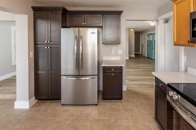 a kitchen with stainless steel appliances granite countertop a refrigerator and a stove
