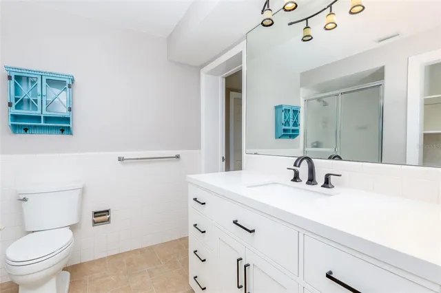 a bathroom with a sink a toilet and mirror