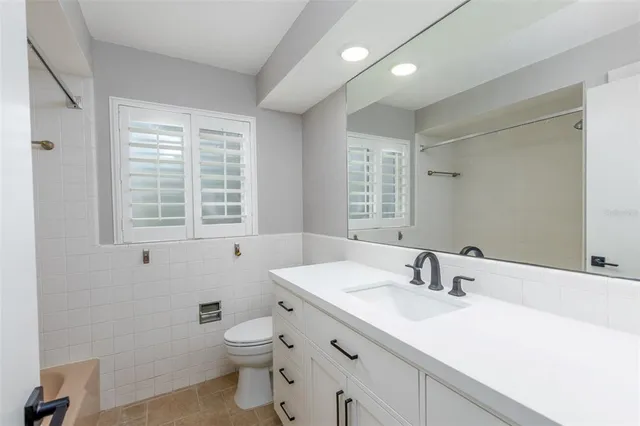 a bathroom with a sink toilet and window