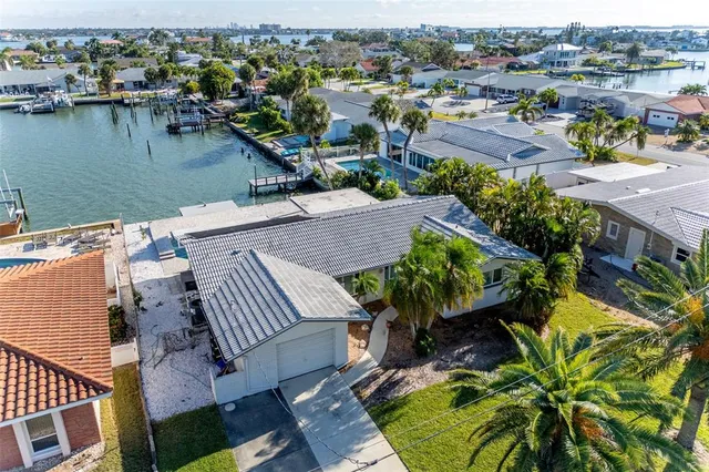 an aerial view of a house with outdoor space and lake view