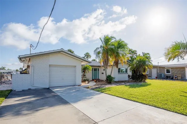 a house view with swimming pool and garden space