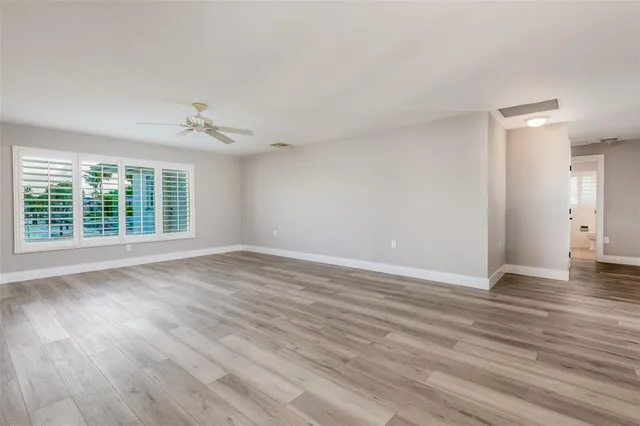 wooden floor in an empty room with a window