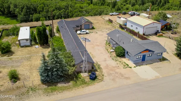 an aerial view of a house with a yard