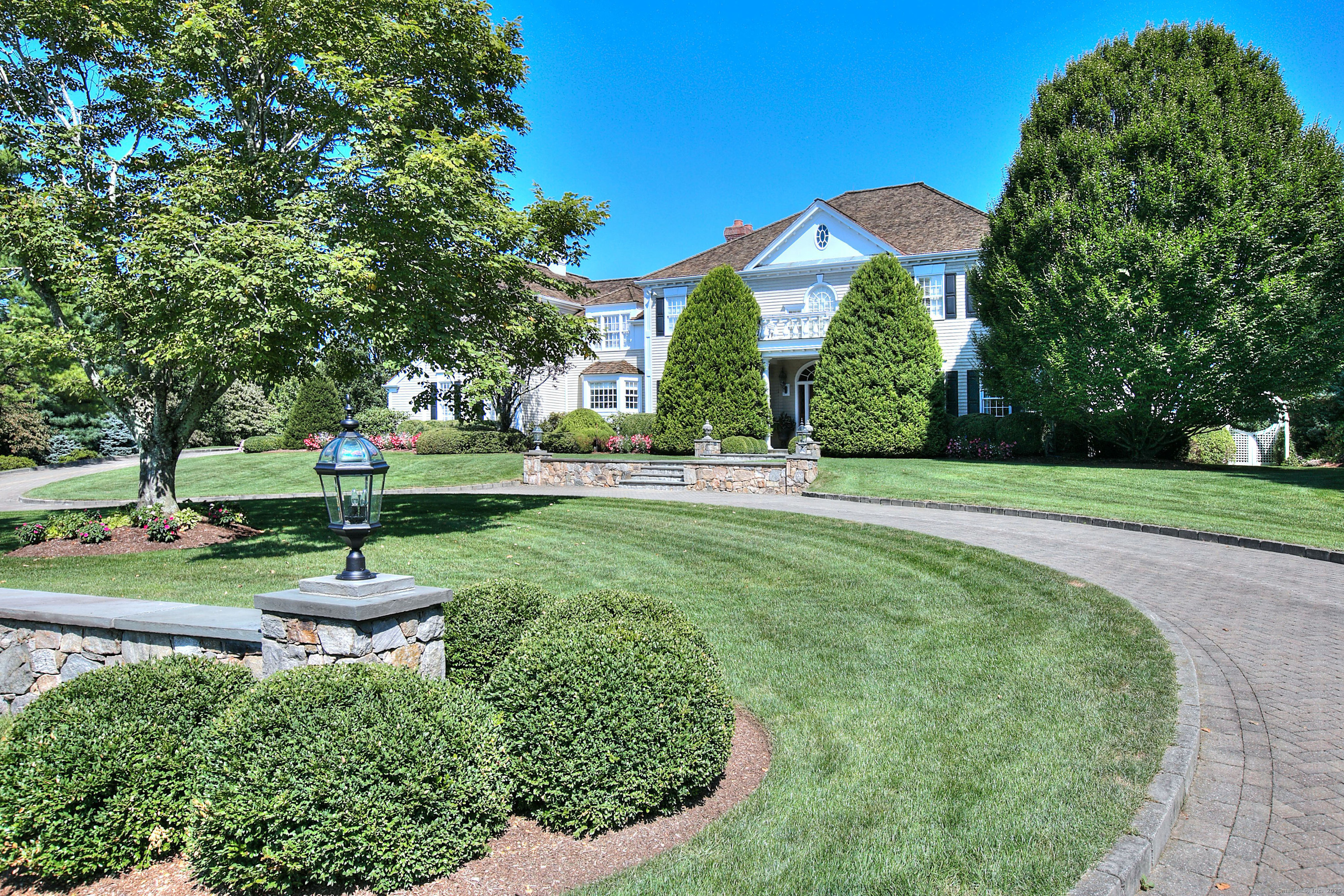 39 Keelers Ridge Road Wilton, CT 06897 - Photo 1 of 1 The front of the house highlighting the right hand side of the circular driveway and the arbor gate to the back yard.