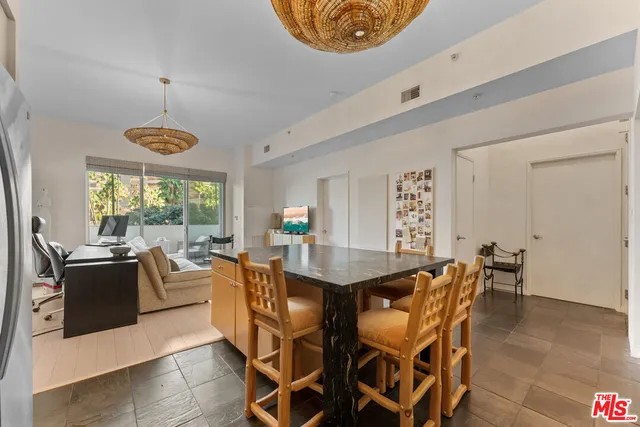 a kitchen with granite countertop a sink a stove and cabinets
