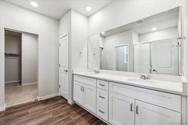 a spacious bathroom with double sink and a mirror