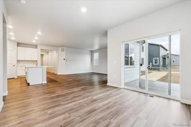 a view of a kitchen with wooden floor and a kitchen