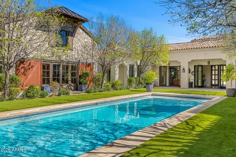 a view of a backyard with swimming pool
