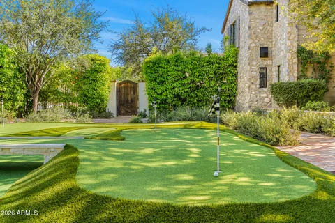 a brick house with a yard and plants