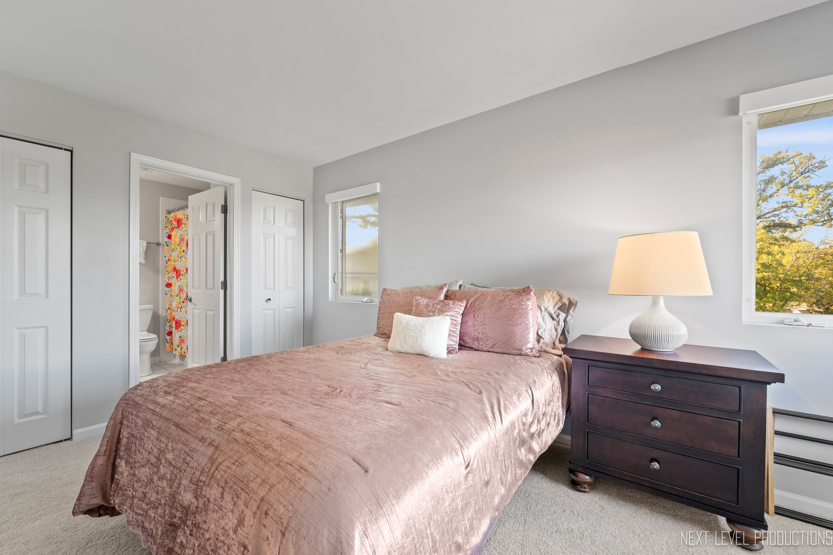 479 River Bend Road, Unit 111 Naperville, IL 60540 - Photo 19 of 25 a bedroom with a bed and a lamp on dresser