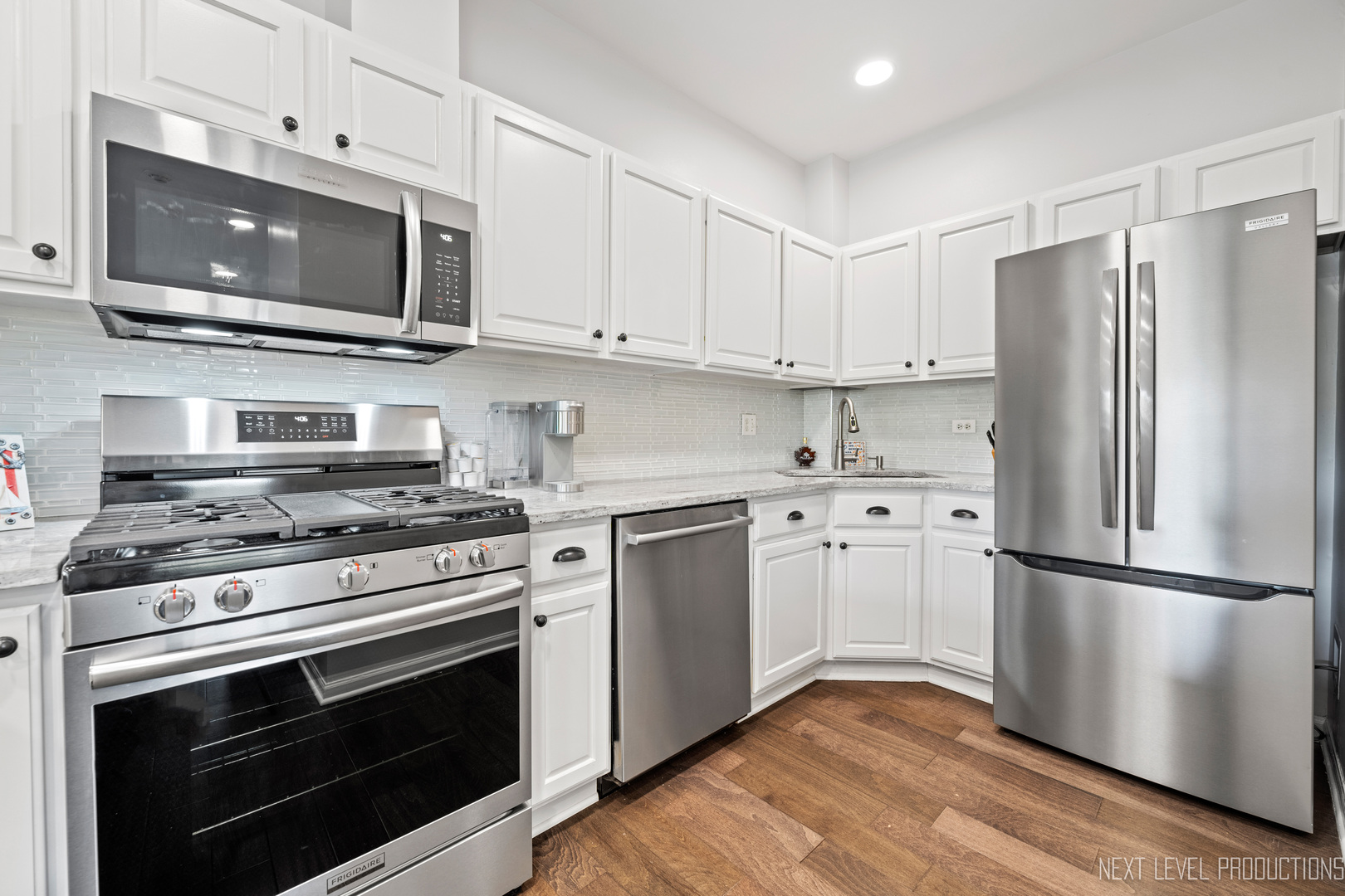479 River Bend Road, Unit 111 Naperville, IL 60540 - Photo 8 of 25 a kitchen with cabinets stainless steel appliances and wooden floor
