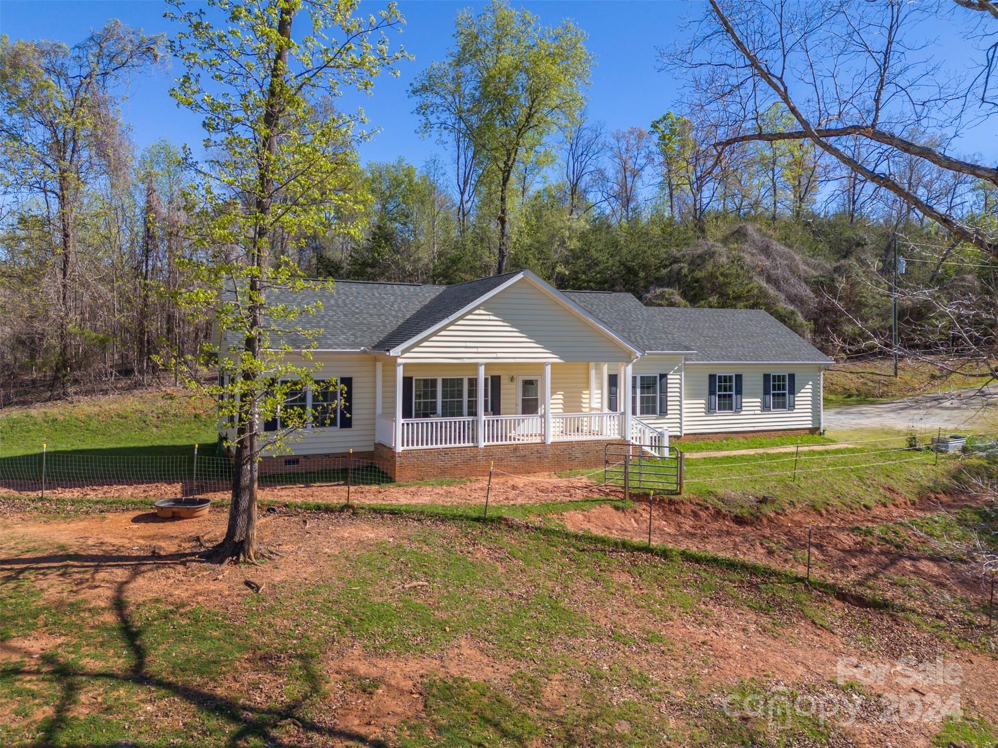 1975 Whiteside Road Mill Spring, NC 28756 - Photo 1 of 37 a front view of a house with a yard