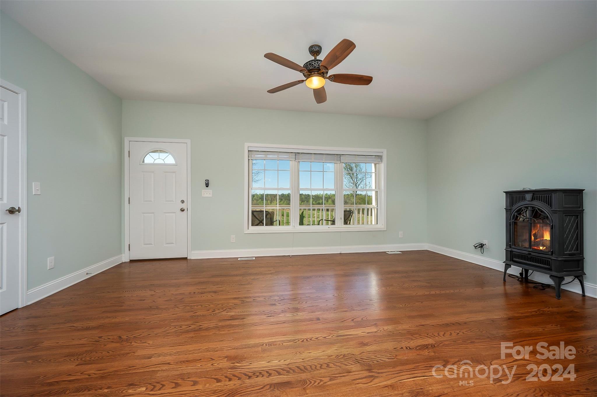 1975 Whiteside Road Mill Spring, NC 28756 - Photo 11 of 37 a view of an empty room with a window and wooden floor