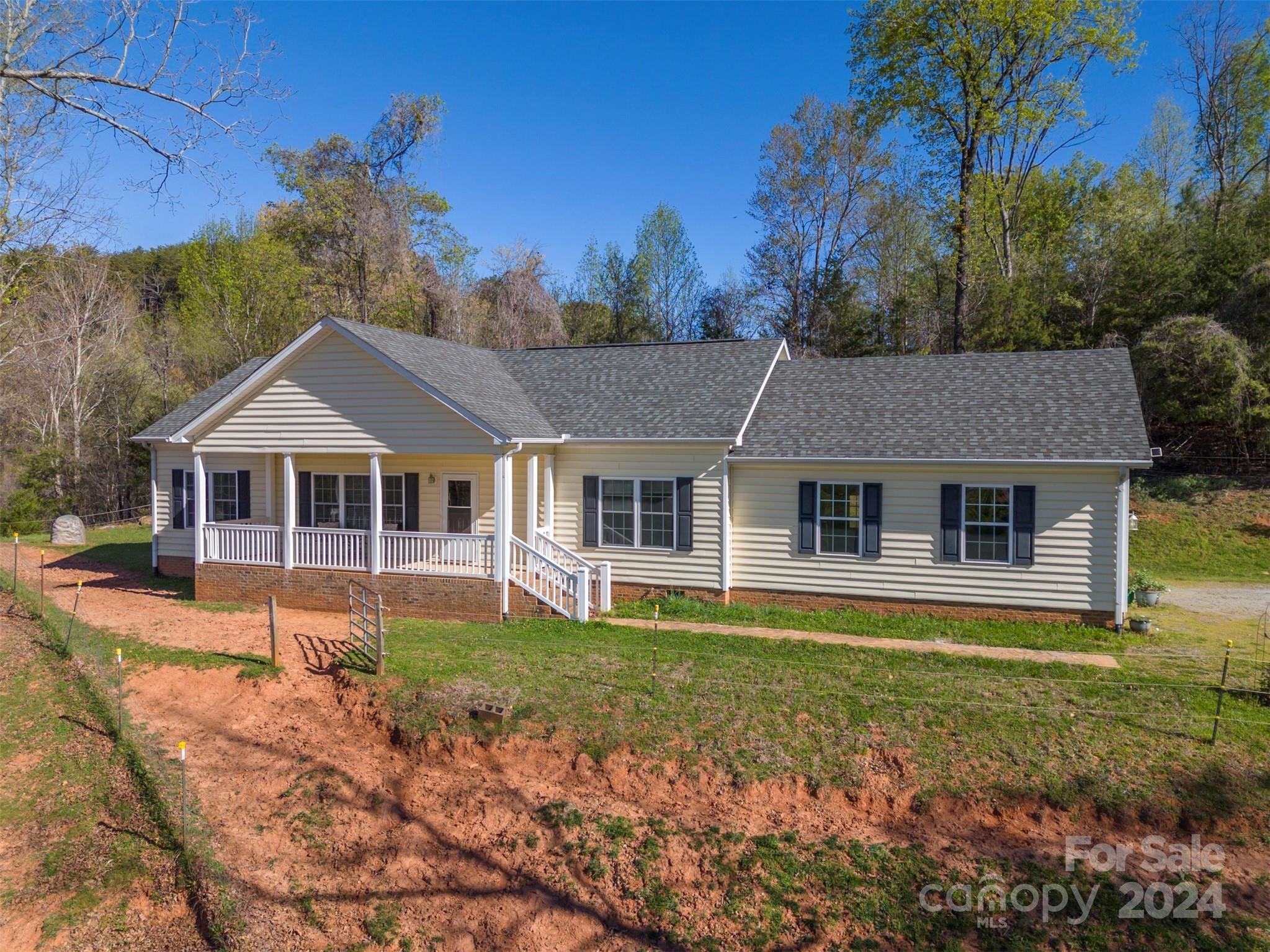 1975 Whiteside Road Mill Spring, NC 28756 - Photo 2 of 37 front view of a house with a yard