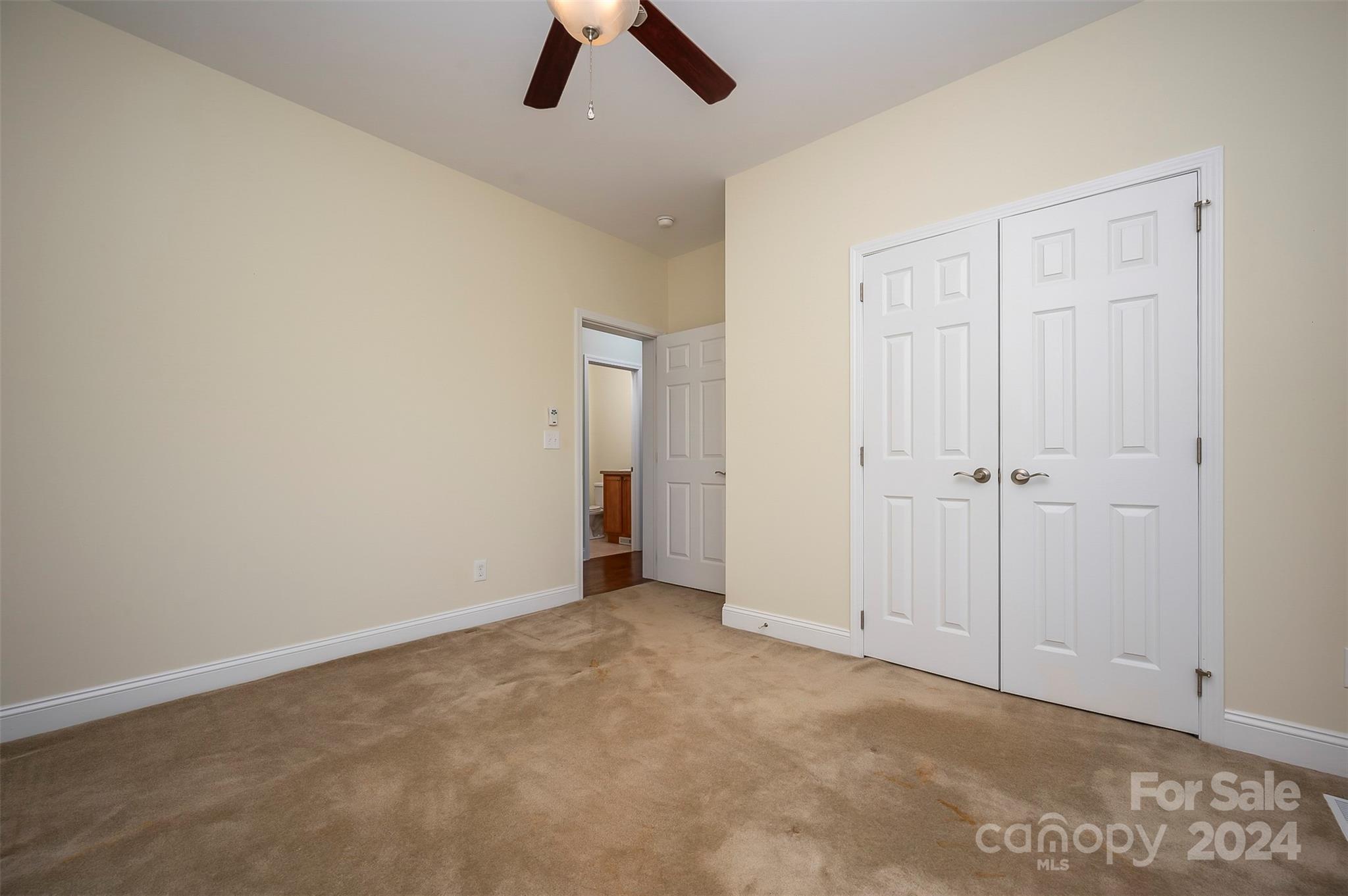 1975 Whiteside Road Mill Spring, NC 28756 - Photo 24 of 37 an empty room with ceiling fan and window