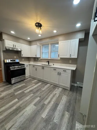 a kitchen with a sink cabinets and window