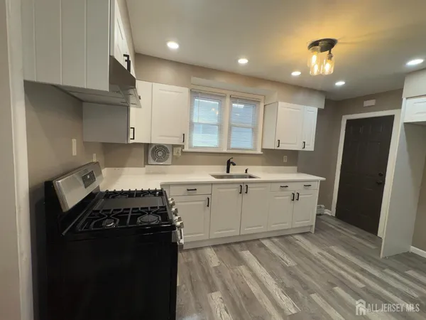 a kitchen with a sink stove and refrigerator