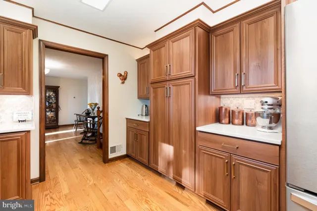 a kitchen with stainless steel appliances granite countertop a stove a sink dishwasher and a microwave oven with wooden floor