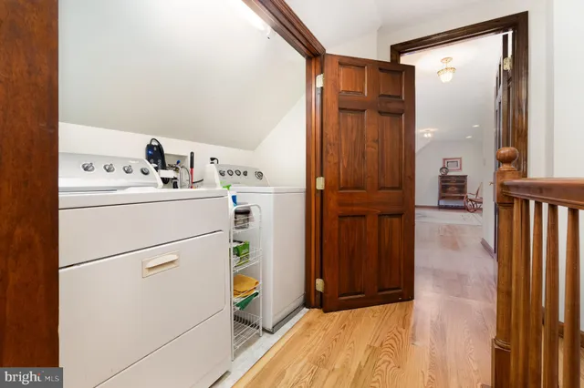 a view of a lake with a table and chairs under an umbrella
