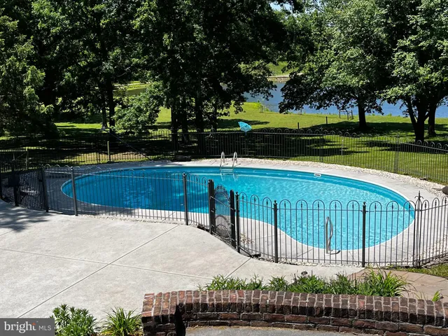 an aerial view of a house with a yard lake and ocean view