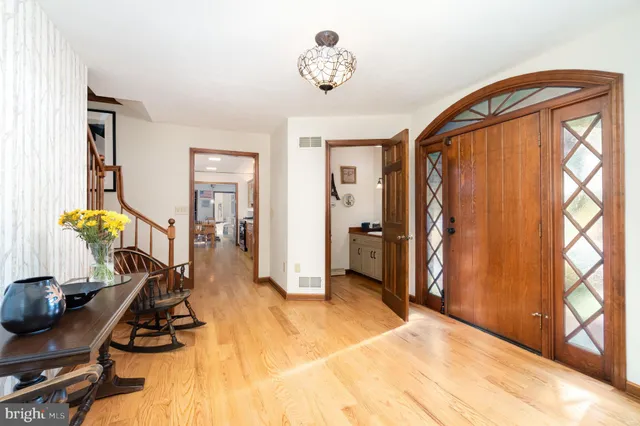 a living room with fireplace furniture and a wooden floor