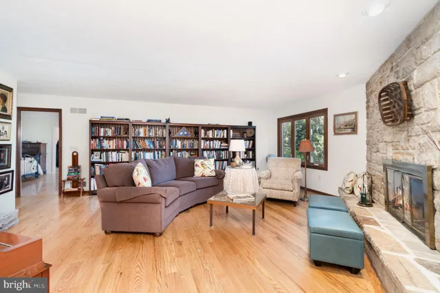 a living room with furniture and a book shelf