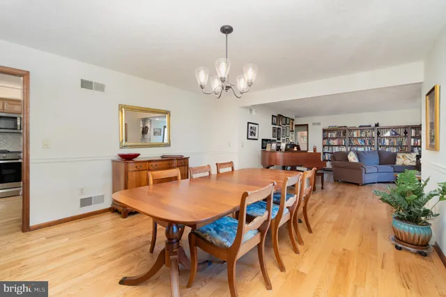a living room with lots of furniture and a chandelier