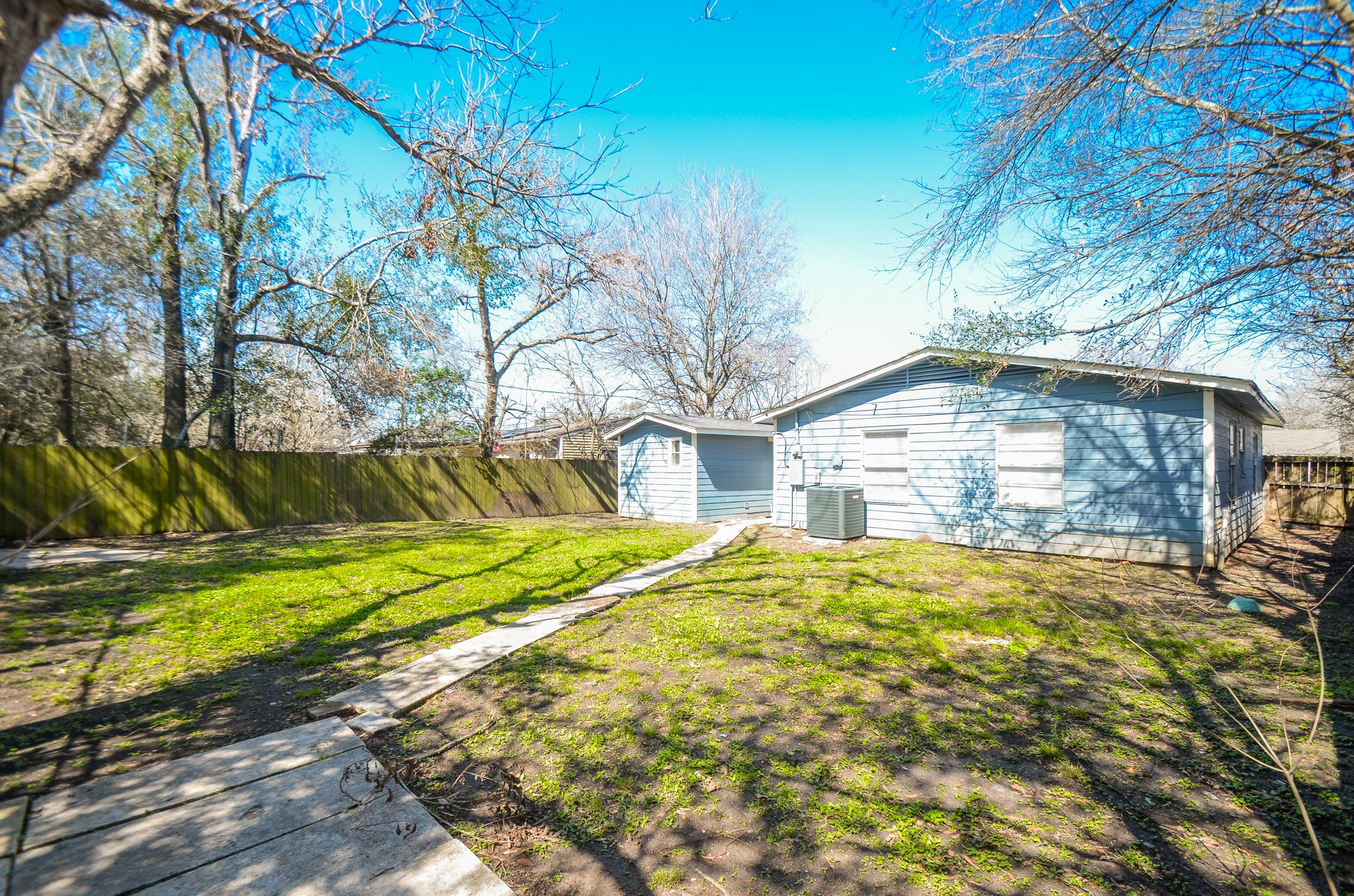 5238 Keystone Street Houston, TX 77021 - Photo 30 of 31 Fully fenced backyard with lush grass and mature trees.