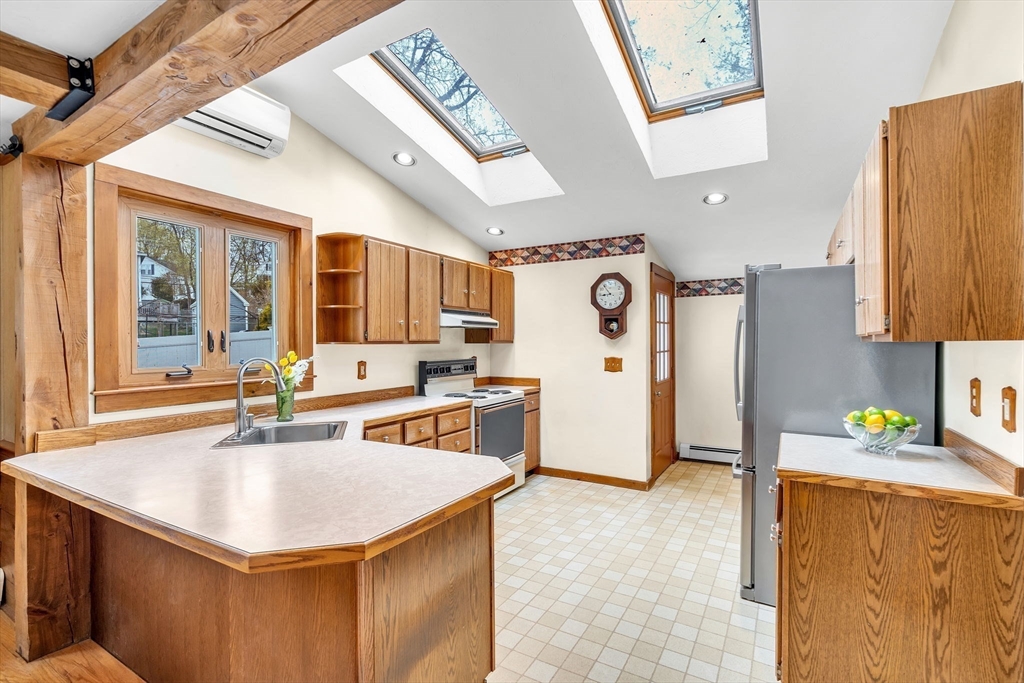 111 Spring Street Marlborough, MA 01752 - Photo 16 of 42 a kitchen with stainless steel appliances a sink stove and a refrigerator