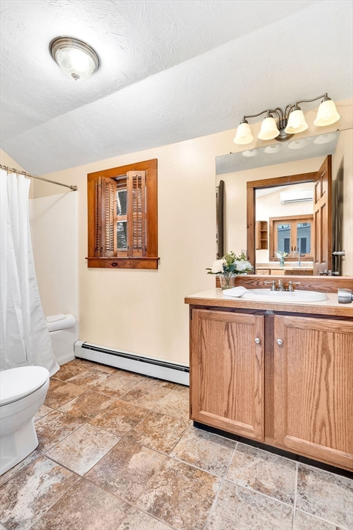 111 Spring Street Marlborough, MA 01752 - Photo 24 of 42 a bathroom with a sink a mirror and a toilet