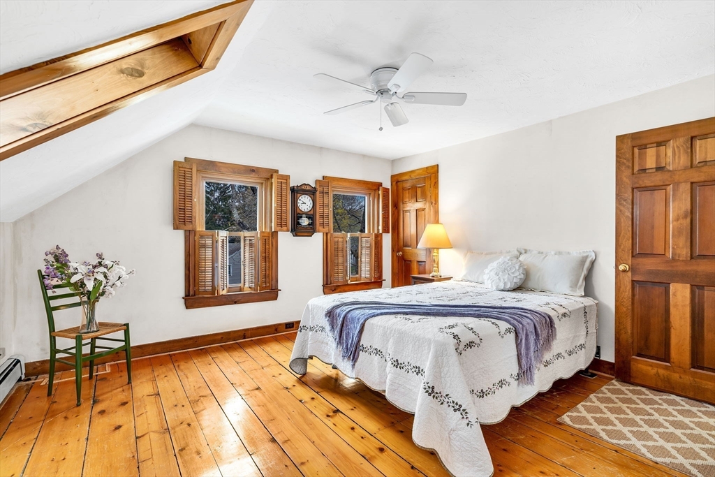111 Spring Street Marlborough, MA 01752 - Photo 27 of 42 a bedroom with a bed and wooden floor