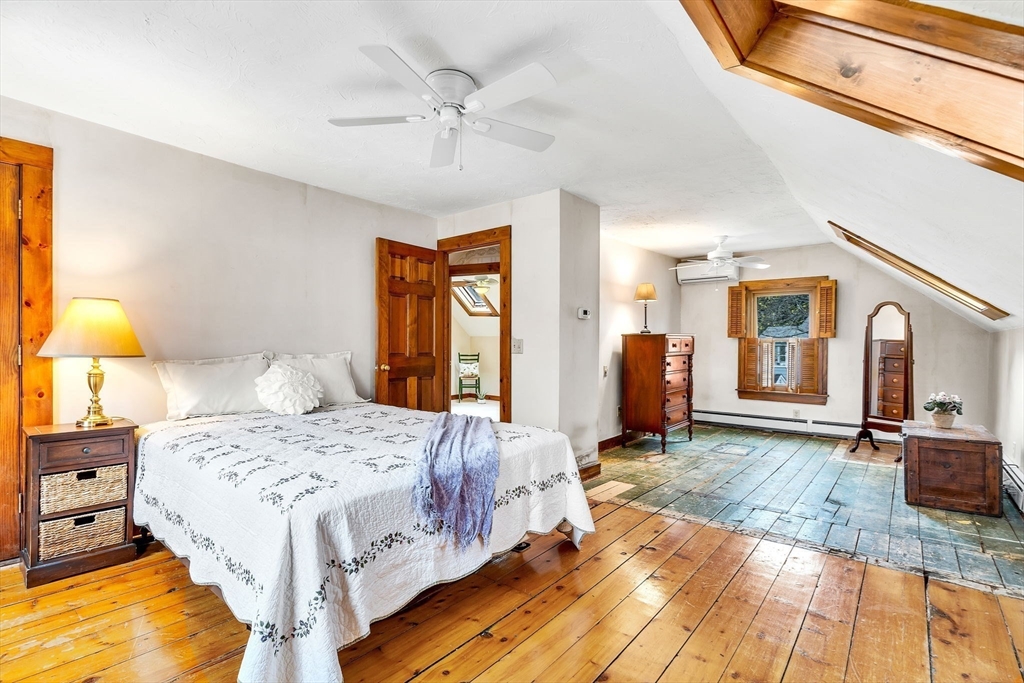 111 Spring Street Marlborough, MA 01752 - Photo 29 of 42 a bedroom with a bed and wooden floor