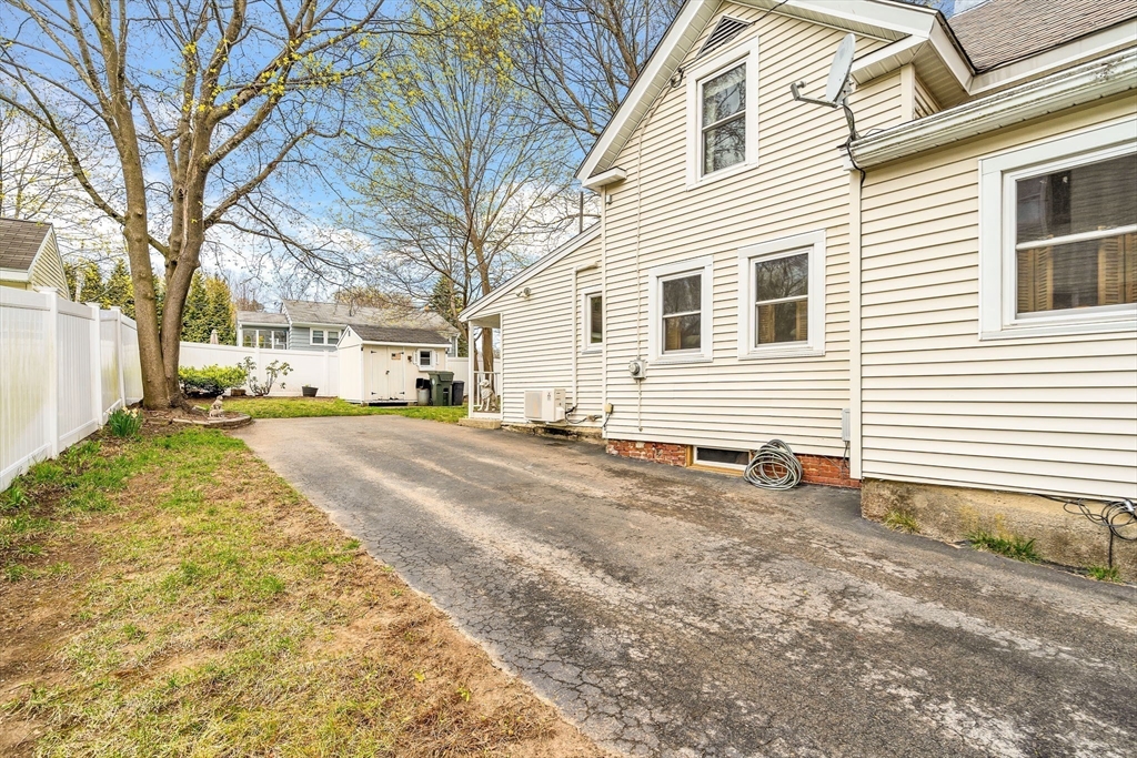 111 Spring Street Marlborough, MA 01752 - Photo 36 of 42 a view of a white house with a yard and sitting area