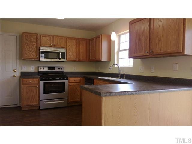 2900 Oneida Court Raleigh, NC 27610 - Photo 2 of 7 a kitchen with a sink a microwave and cabinets