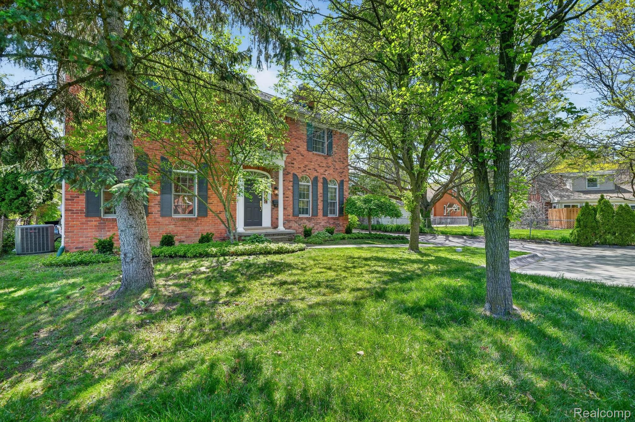 1112 Vernier Road Grosse Pointe, MI 48236 - Photo 2 of 39 View of front of house with brick siding and a front lawn