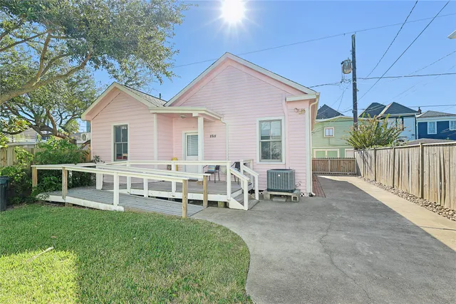 a view of a house with a yard and sitting area