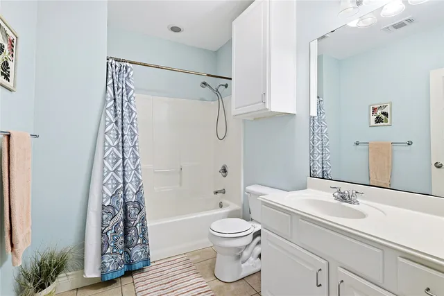 a bathroom with a shower a toilet and a sink