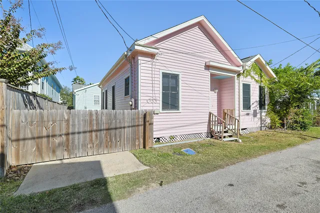 a view of a house with a yard and sitting area