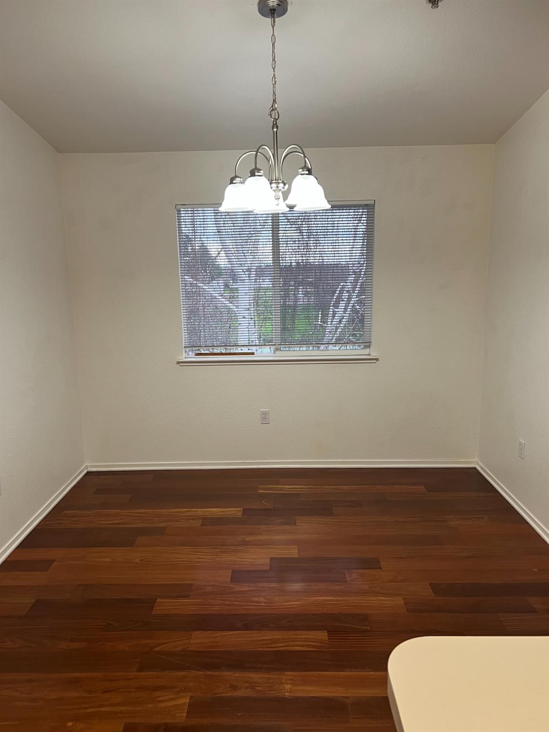 565 Peerless Way, Unit 302 Tracy, CA 95376 - Photo 6 of 17 a view of wooden floor chandelier and closet in a room