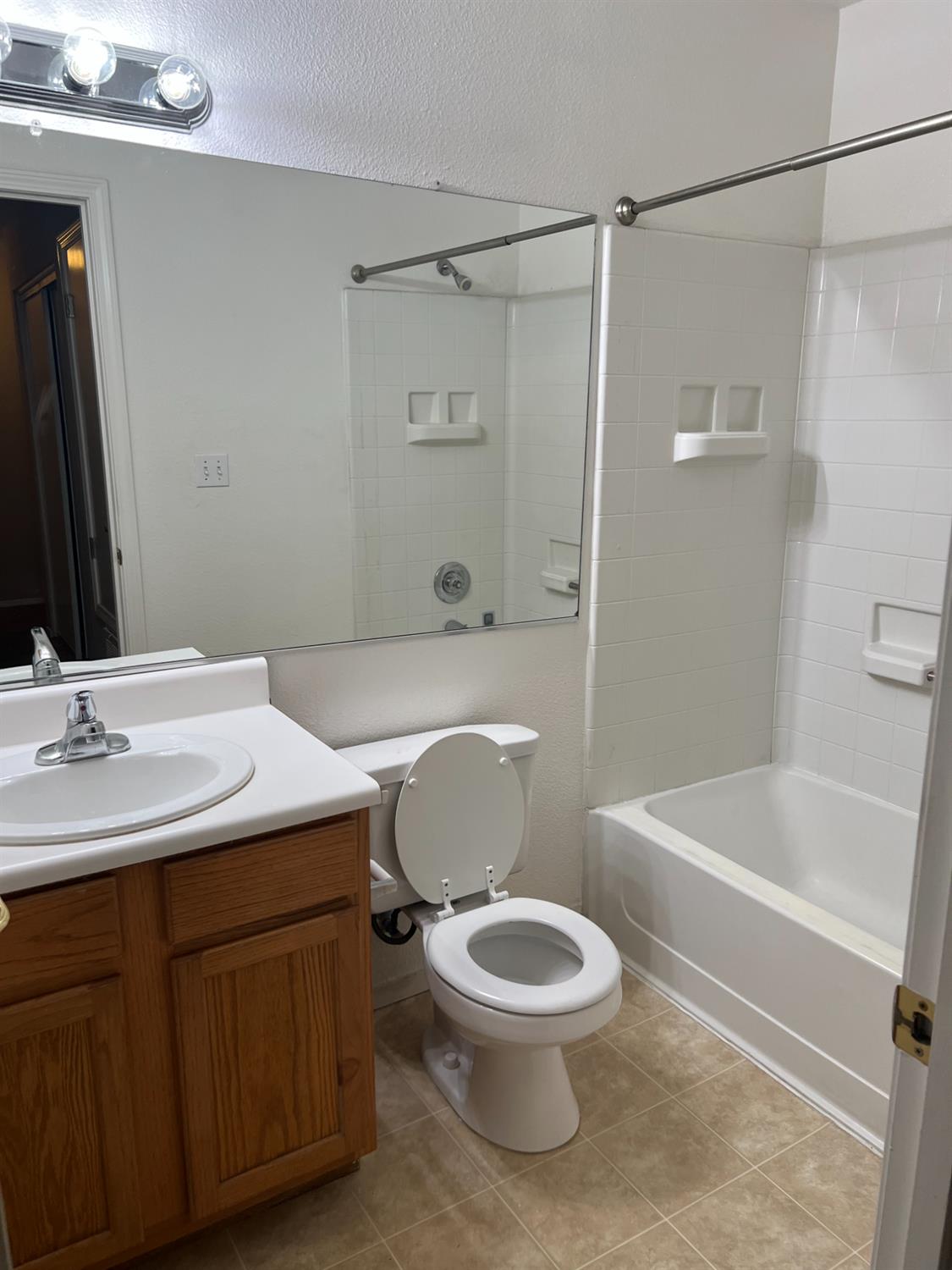565 Peerless Way, Unit 302 Tracy, CA 95376 - Photo 10 of 17 a bathroom with a sink toilet and shower