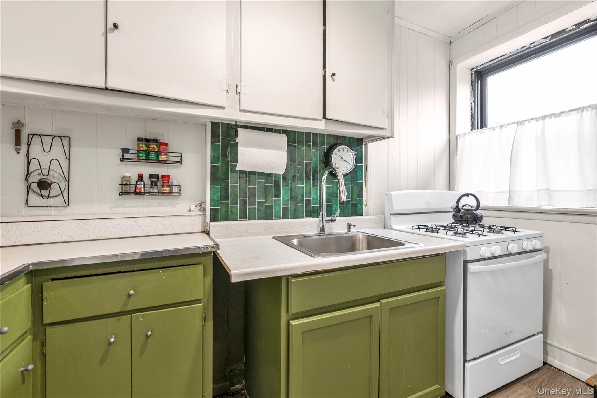 19-54 79th Street, Unit 2 Queens, NY 11370 - Photo 7 of 16 a kitchen with a sink and cabinets