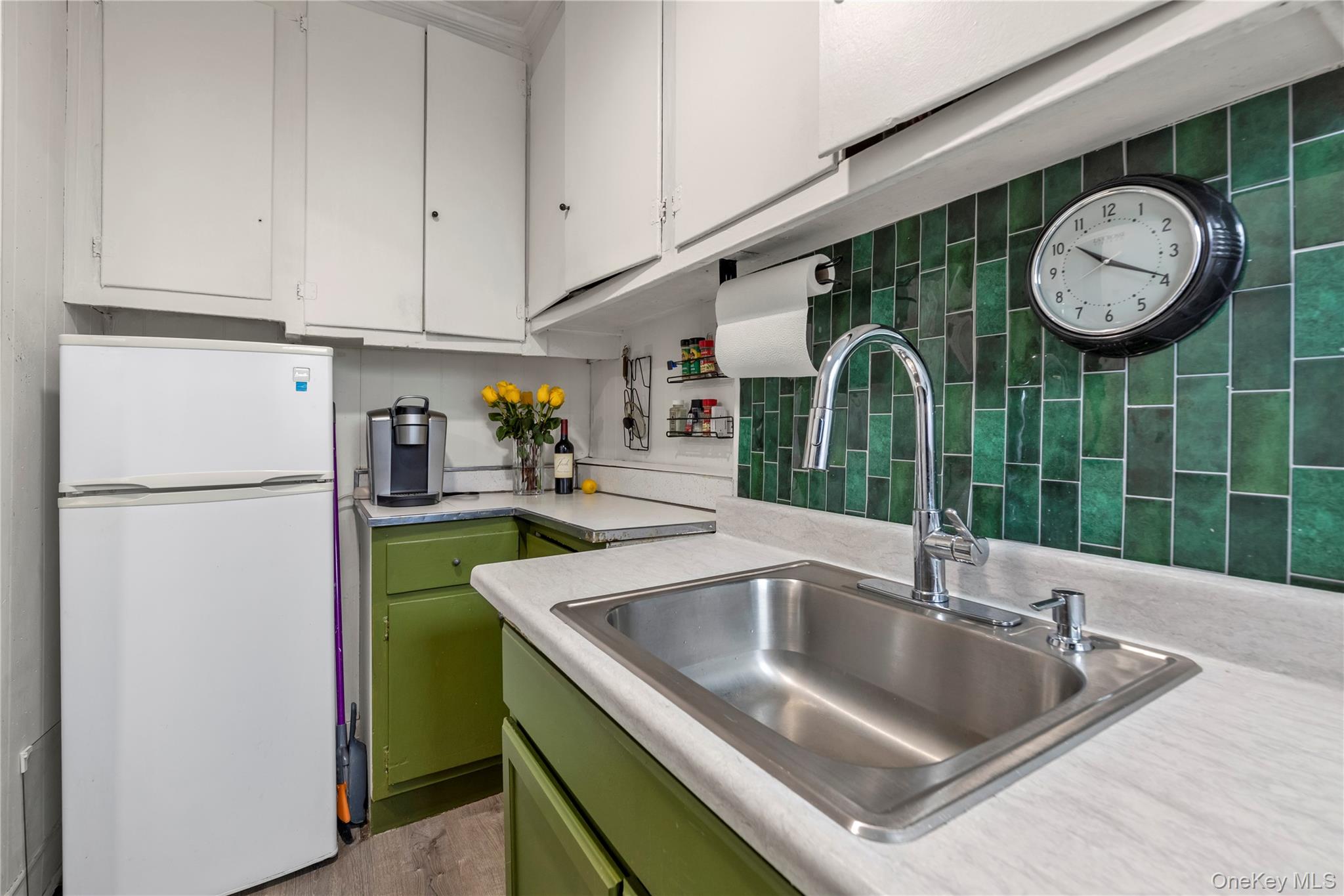 19-54 79th Street, Unit 2 Queens, NY 11370 - Photo 9 of 16 a kitchen with a refrigerator a sink and cabinets