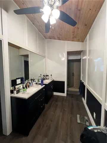 a bathroom with a sink vanity and a mirror
