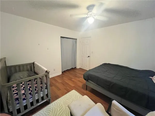 a bedroom with furniture and wooden floor