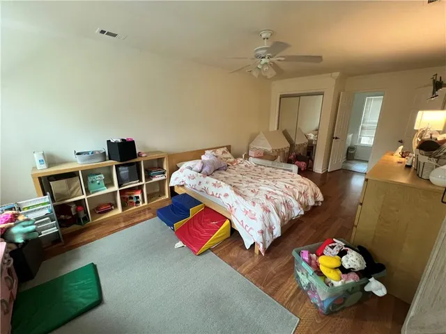 a bedroom with bed and a chandelier