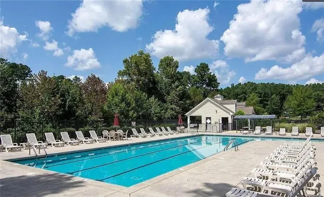 a view of house with outdoor space and sitting area