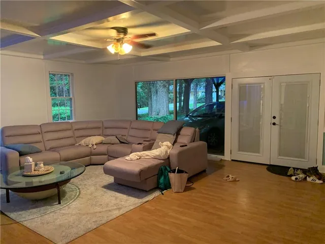 a living room with furniture and a chandelier
