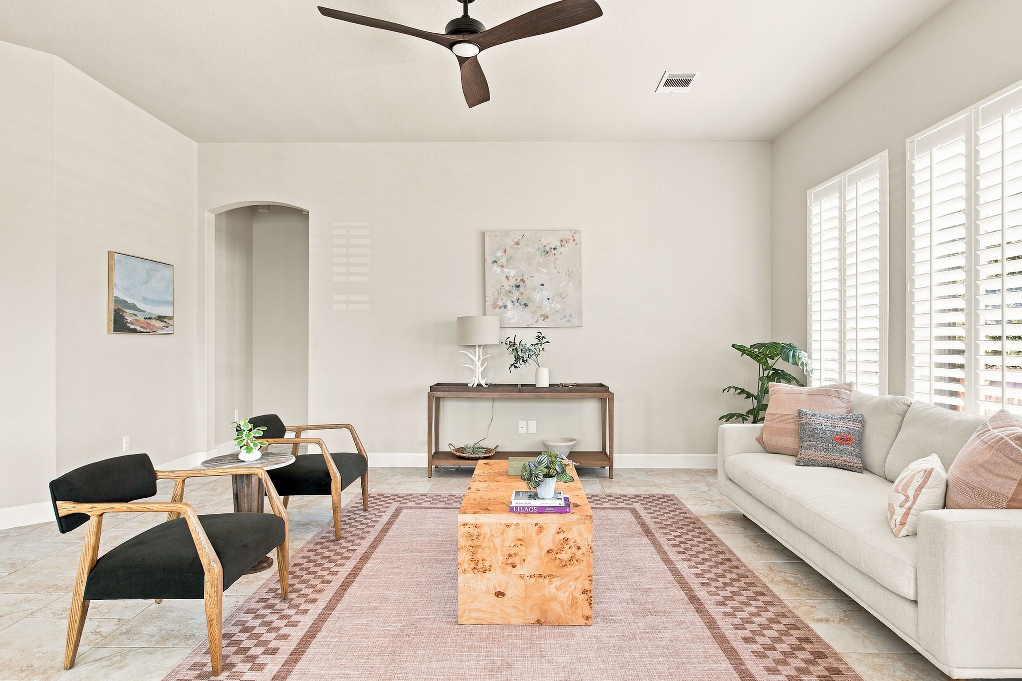 6100 Gunnison Turn Road Austin, TX 78738 - Photo 16 of 34 Natural light pours through plantation shutters onto the tiled floor of this airy living area.