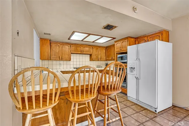 a view of a kitchen with a dining table and chairs